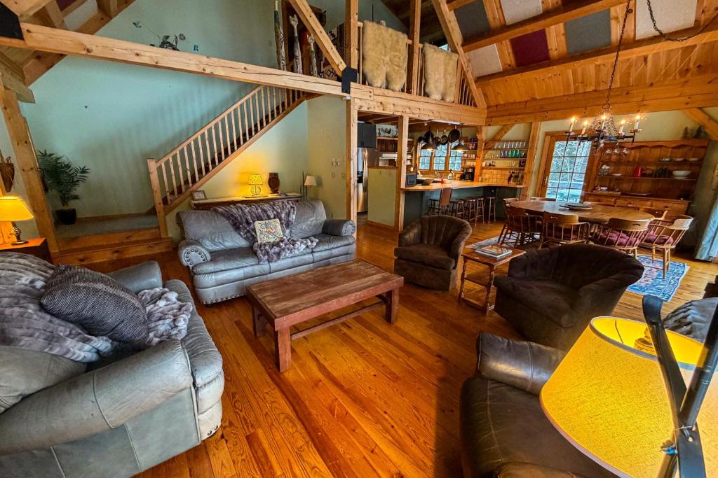 a living room with couches and a dining room at Blue Goose in Ludlow