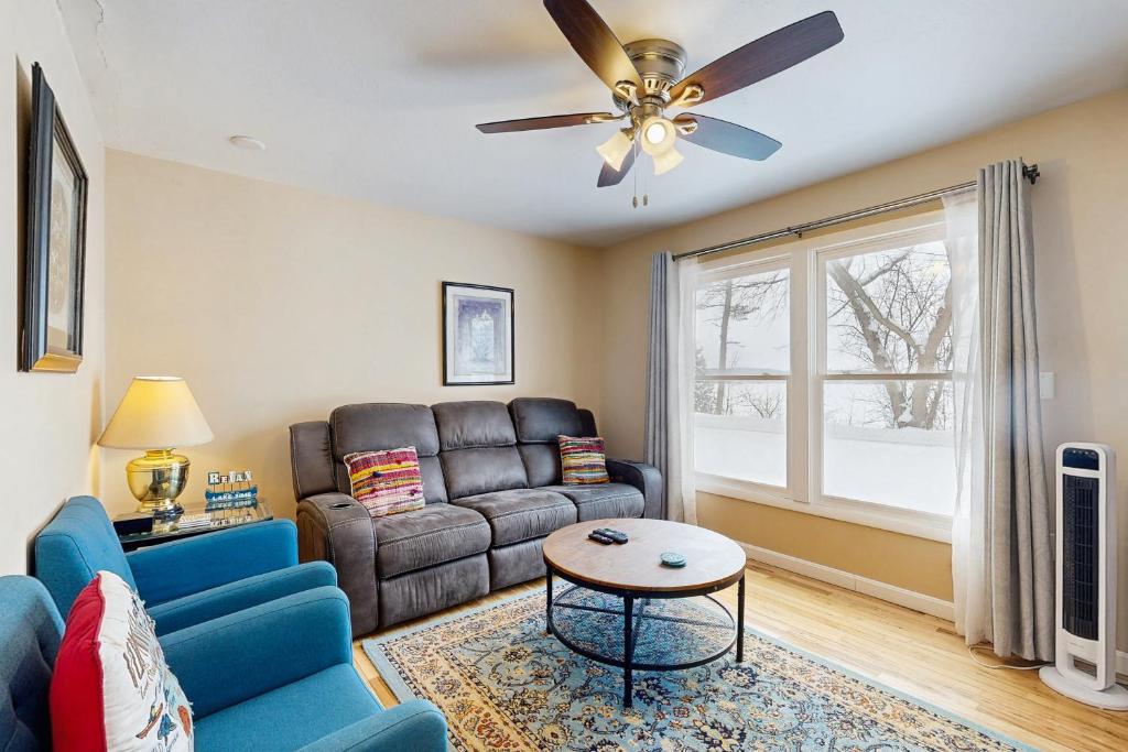 a living room with a couch and a ceiling fan at Champ's Camp in Colchester