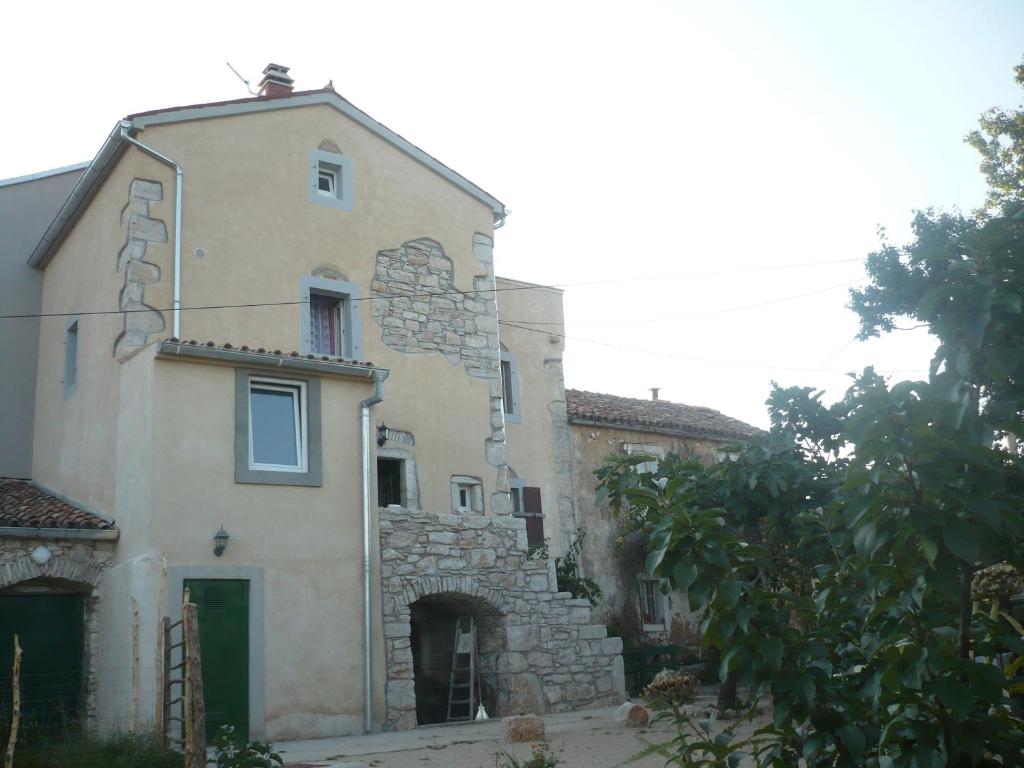 an old house with a stone building at House Dragica in Cres