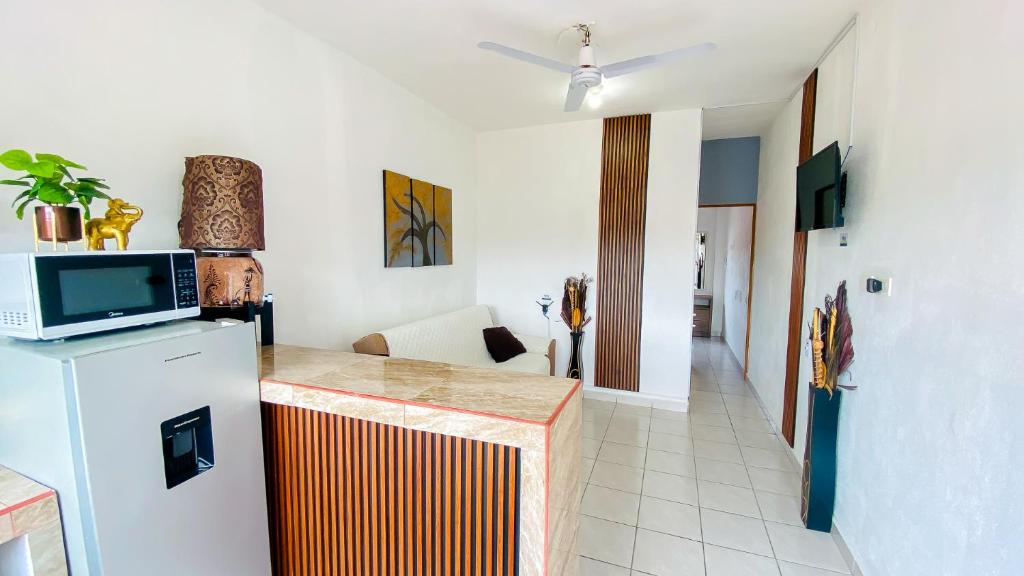 a kitchen with a refrigerator and a counter with a microwave at Depa Altavela en Bahía, Hospital IMSS 33 muy cerca in Mezcales
