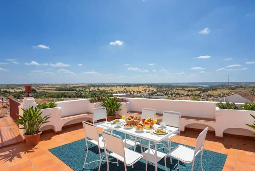 a patio with a table and chairs on a balcony at SOLO ! Charme Boutique in Avis