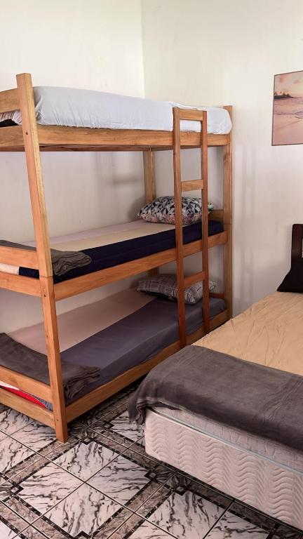 a room with two bunk beds and a bed at Pousada Rensule in Bertioga