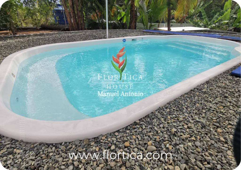 a swimming pool in the middle of a resort at Flortica House Manuel Antonio in Quepos