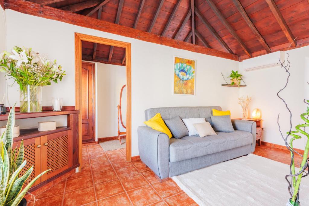 a living room with a couch and a table at Casa Petra - Traditional Canary House in Güimar