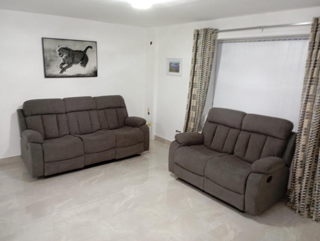 a living room with two couches and a couch at the foyle bridge apartment in Derry Londonderry