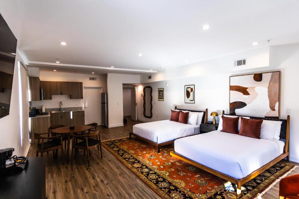 a hotel room with two beds and a table at The Sierra House in Mammoth Lakes