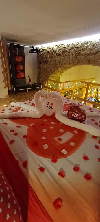 a bed with red flowers on it with hearts on it at Nina in Love in Salerno