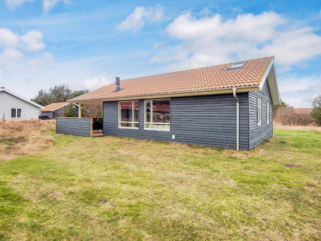 a house with a large yard in front of it at 4 star holiday home in Ulfborg in Fjand Gårde