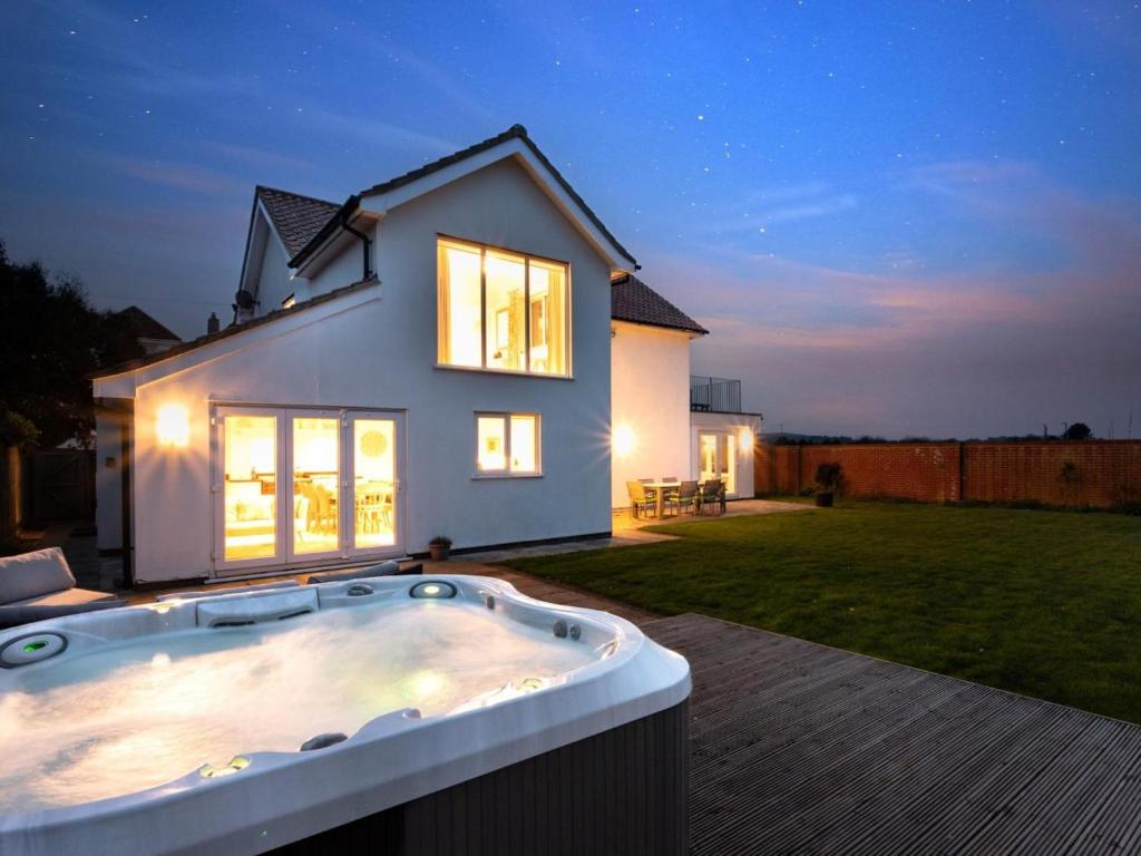 a house with a hot tub in the yard at 4 Bed in Cromer oc-81469 in West Runton