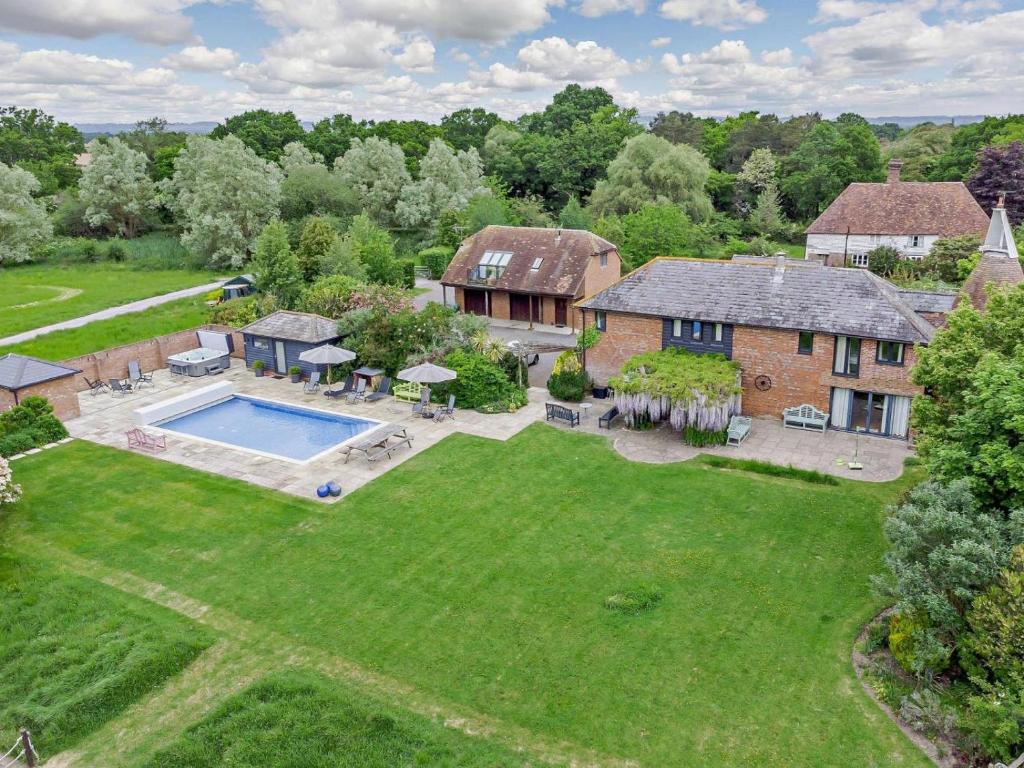 an aerial view of a house with a large yard at 5 Bed in Ashford oc-76428 in Smarden