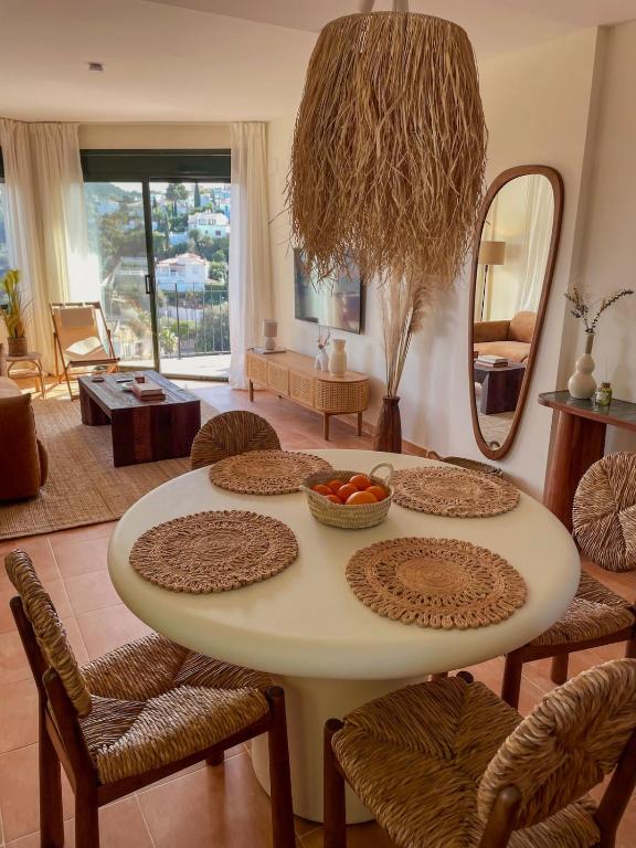 a table with a bowl of fruit on it in a living room at Seren Casa Begur - Illa Roja Beach in Begur