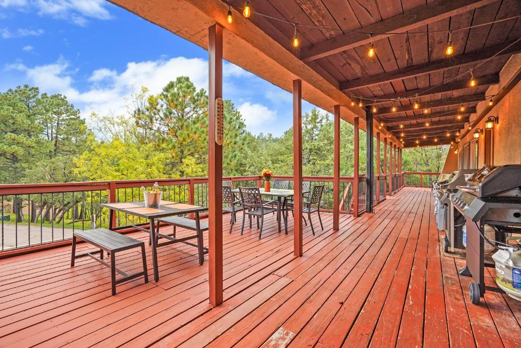 a wooden deck with tables and chairs and a grill at Airy Alto Escape Deck Games Views in Sun Valley