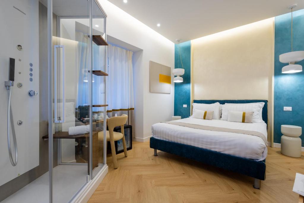 a hotel room with a bed and a bathroom at Barberini Design Suites in Rome