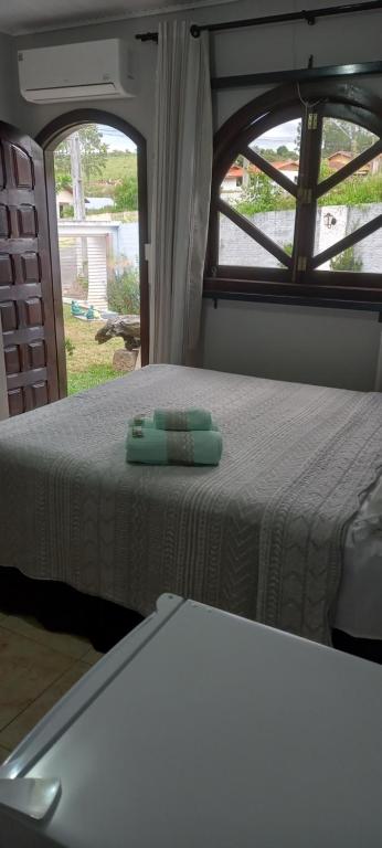 a bed in an rv with a green item on it at Pousada Ruby in Irati