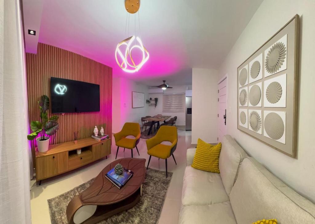 a living room with a couch and a tv at San Isidro Urban suite in Juan López