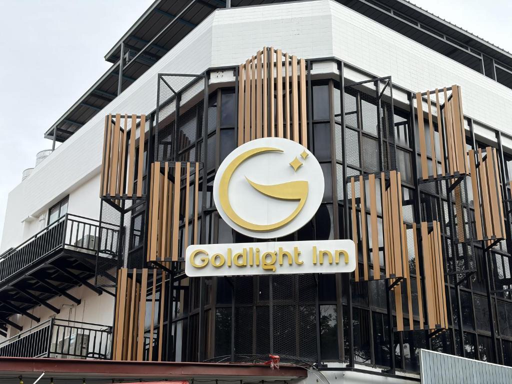 a building with a cuddlingatch inn sign on it at Goldlight Inn in Miri
