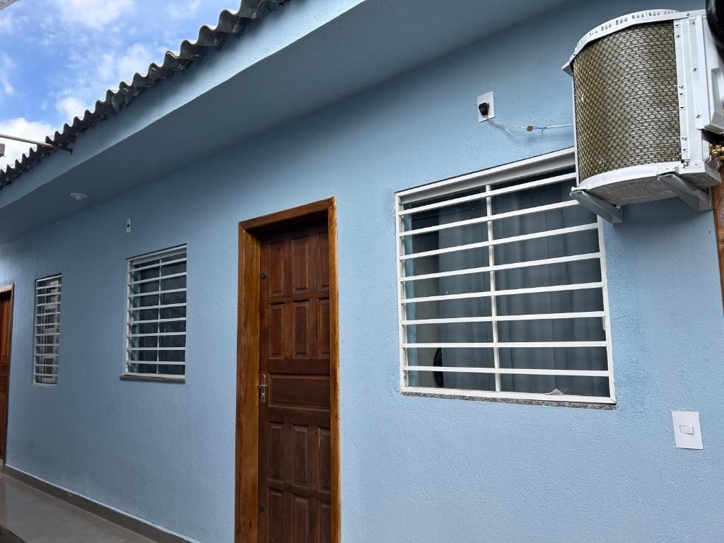 a blue building with a door and a window at Cantinho do Descanso in Cascavel