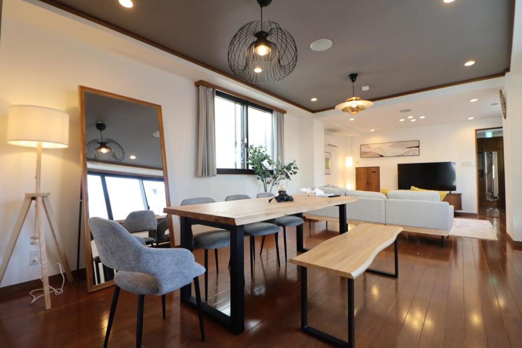 a dining room and living room with a table and chairs at Yokohama Mega Stay in Yokohama