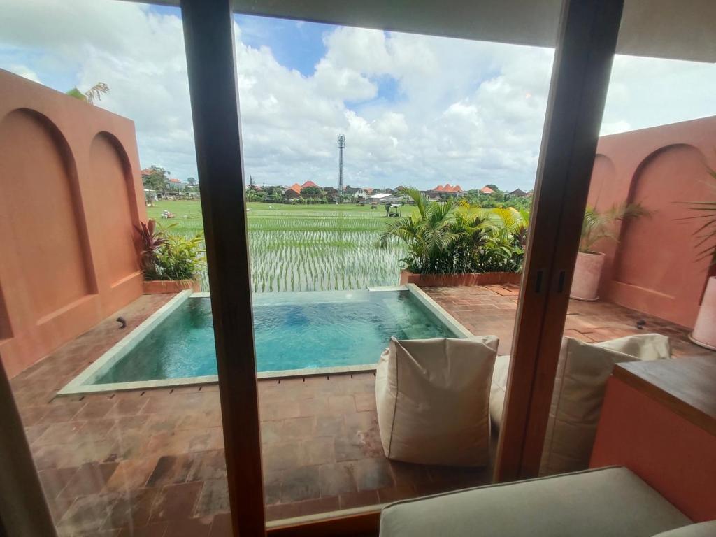a view of a pool from the balcony of a house at Buduk villa in Dalung