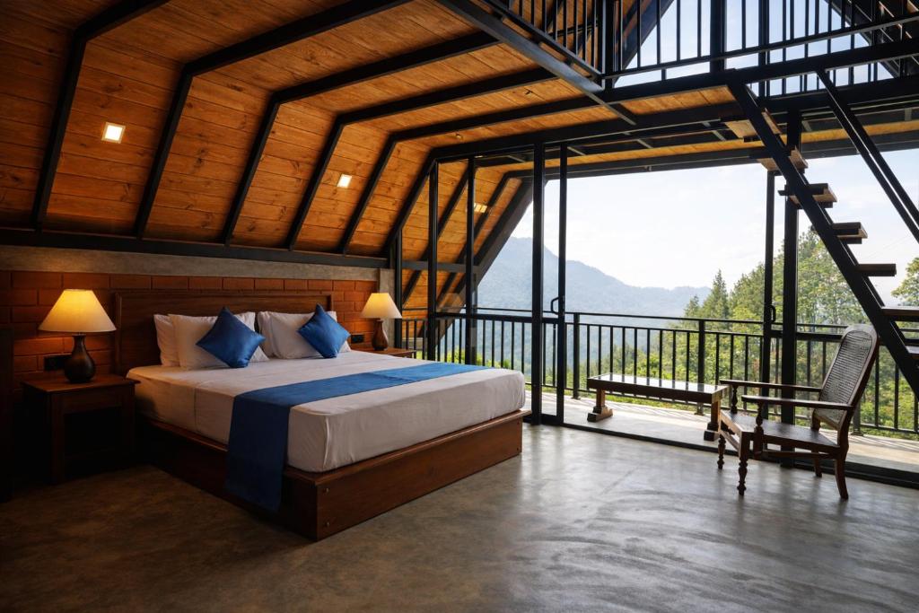 a bedroom with a bed and a balcony with a view at Forest Edge Resort in Kitulgala