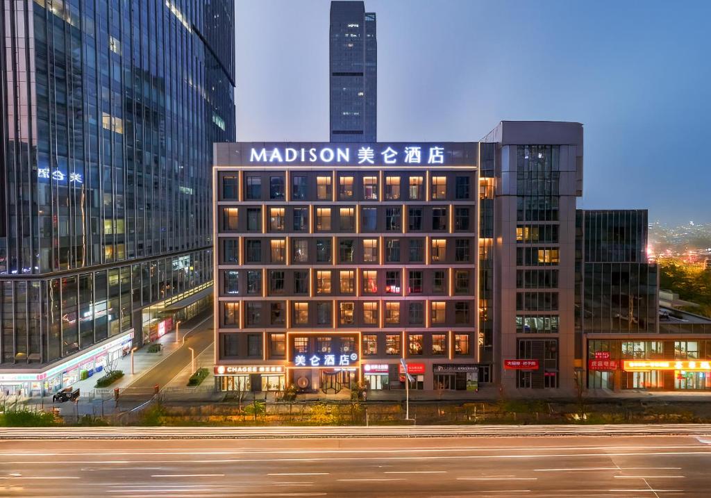 a building with a sign on the top of it at Madison Hotel Jinan CBD in Jinan
