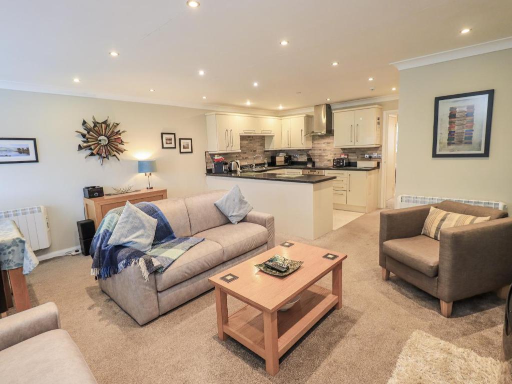 a living room with a couch and chairs and a table at Lakeland Loft in Windermere