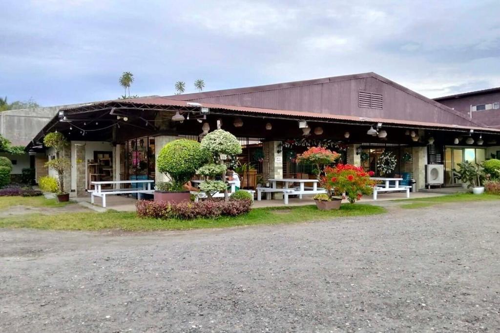 a building with tables and flowers in front of it at Hotel P INC General Santos in General Santos