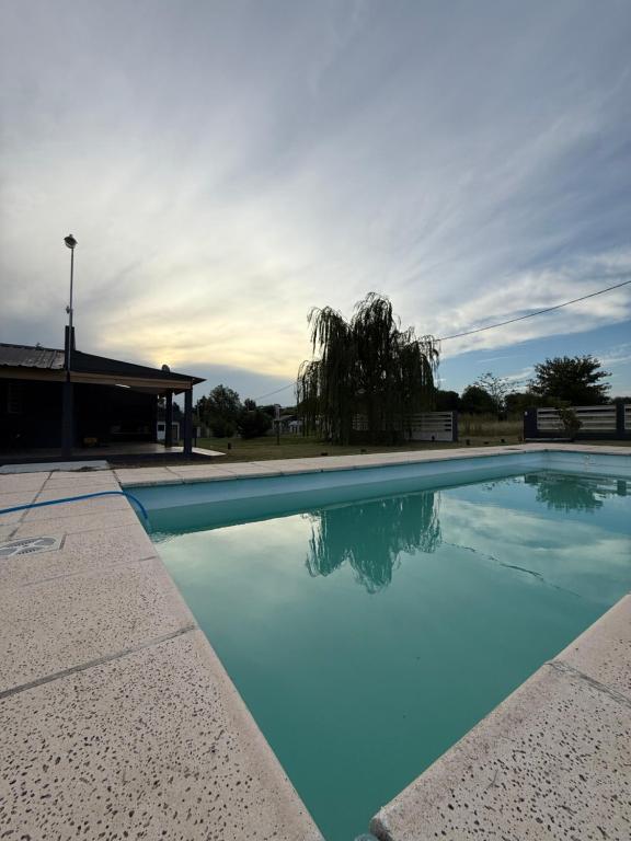 a swimming pool with blue water in front of a building at Potrero Village Suites Refugios Serranos in Potrero de Garay