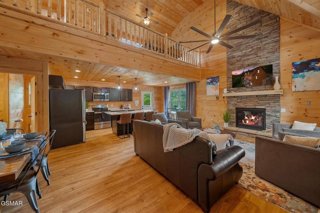 a living room with wooden walls and a fireplace at Cabin in Sevierville in Sevierville