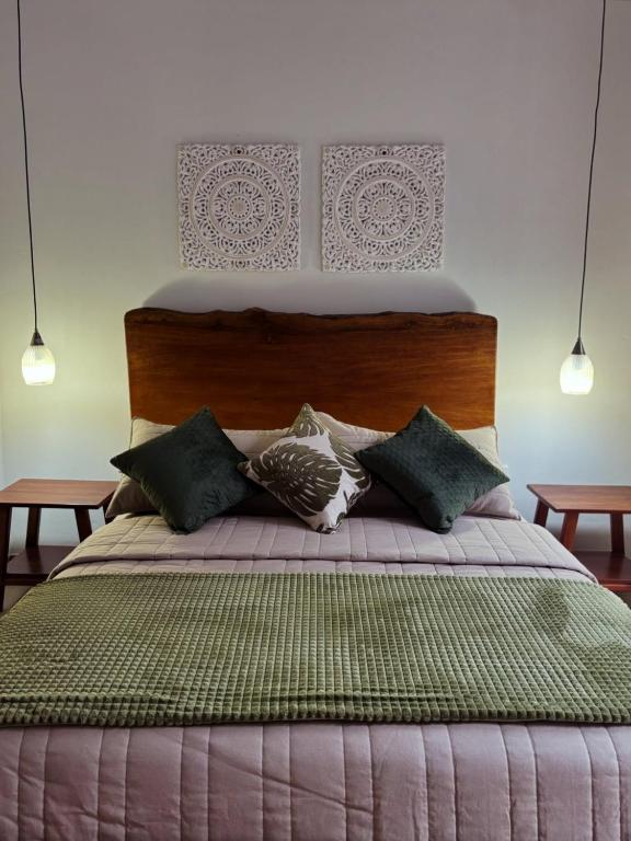 a bedroom with a large bed with pillows on it at Villa Monarca - Markinkia Estancia Amazónica in Macas