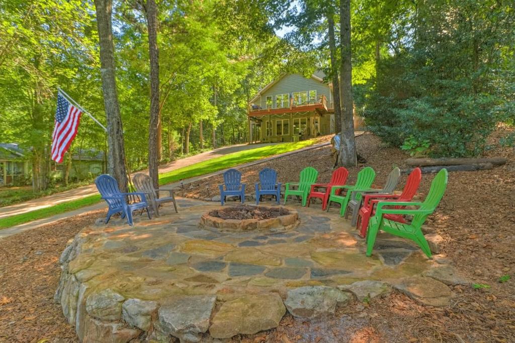 a group of colorful chairs sitting around a fire pit at Dockside Lakefront Escape Deck Views in Jacksons Gap