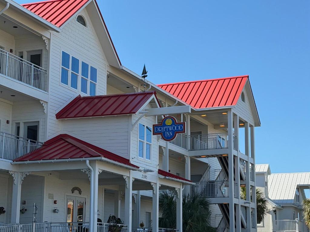 a building with red roofs and a hotel at Driftwood Inn in Mexico Beach