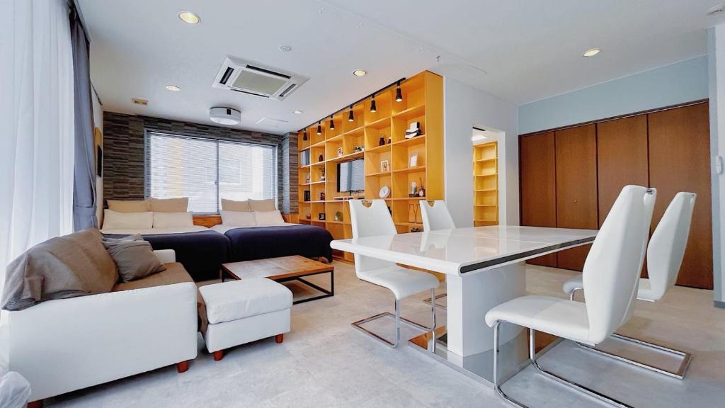 a living room with a table and a couch at Fierement inn in Sapporo