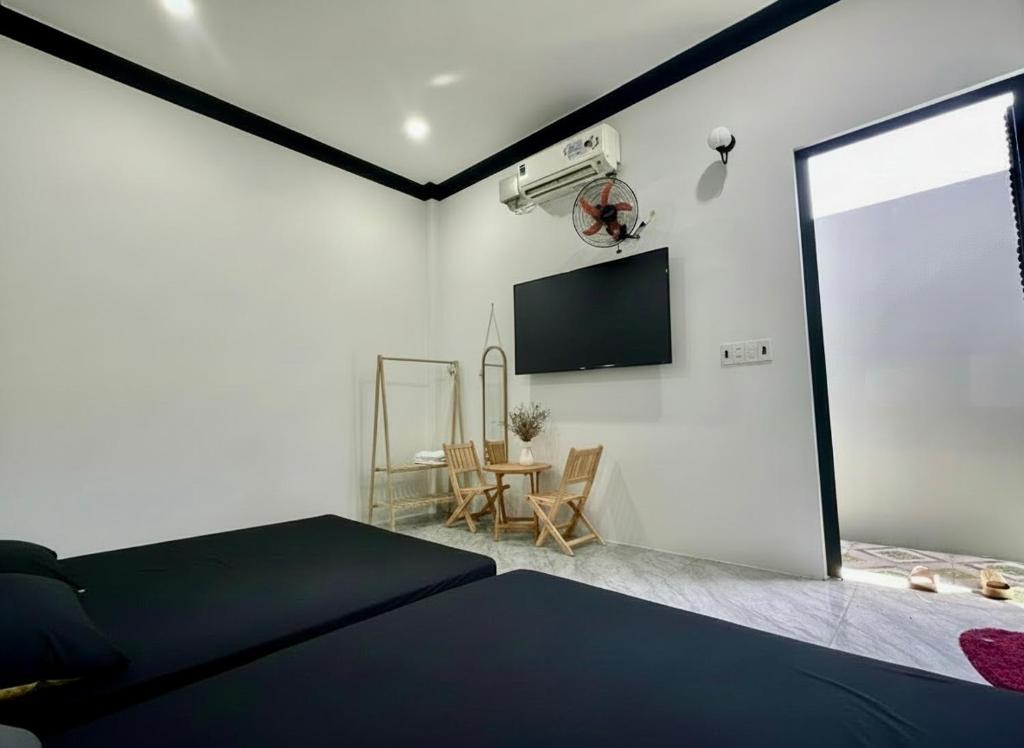a bedroom with a bed and a tv on the wall at Hera motel in Xã Như Lâm