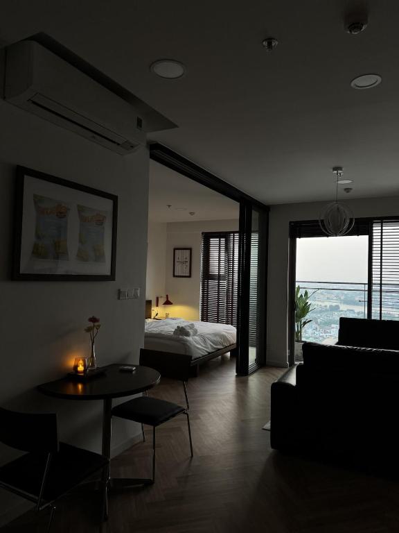 a bedroom with a bed and a table and a couch at CARTER Flat in Ho Chi Minh City
