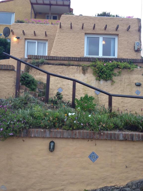 uma casa com um jardim ao lado em Turquesa em El Quisco