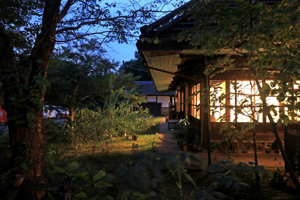 a house at night with the lights on at shoya yamaguchi in Koibuchi