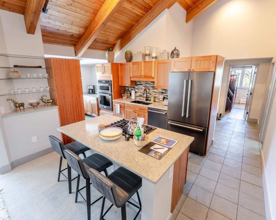 a kitchen with a center island with a refrigerator at Family Snowmass Getaway Minutes To Ski & Village - 229 #36 in Snowmass Village