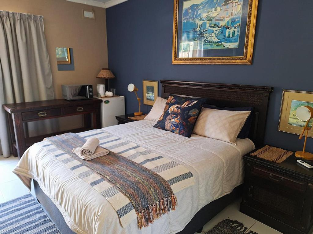 a bedroom with a bed with a towel on it at The Pebble in Howick