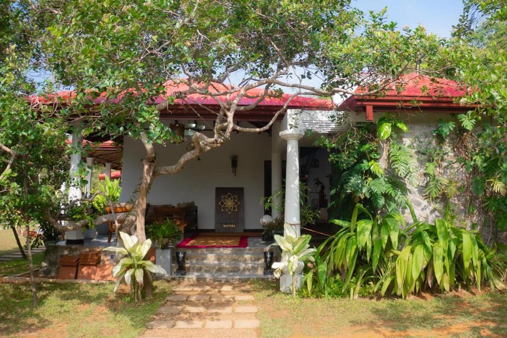 a small house with a red roof at Samaya Waters Bentota in Haburugala