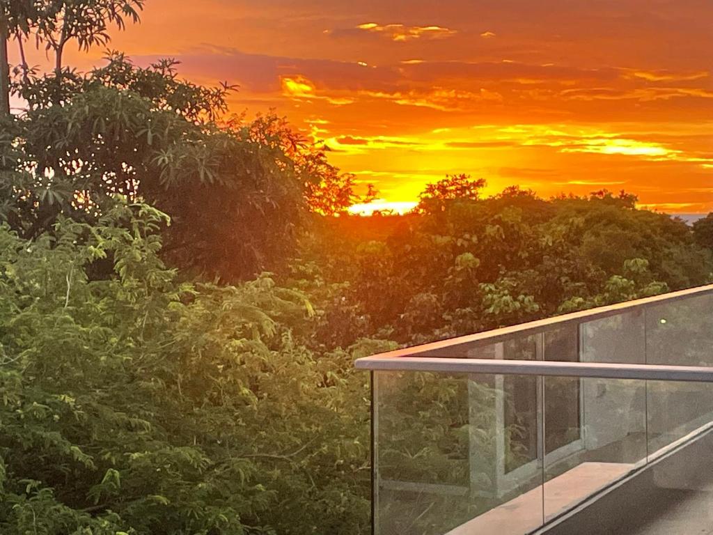 a sunset view from the balcony of a house at Le Grand Bleu in Koh Samui
