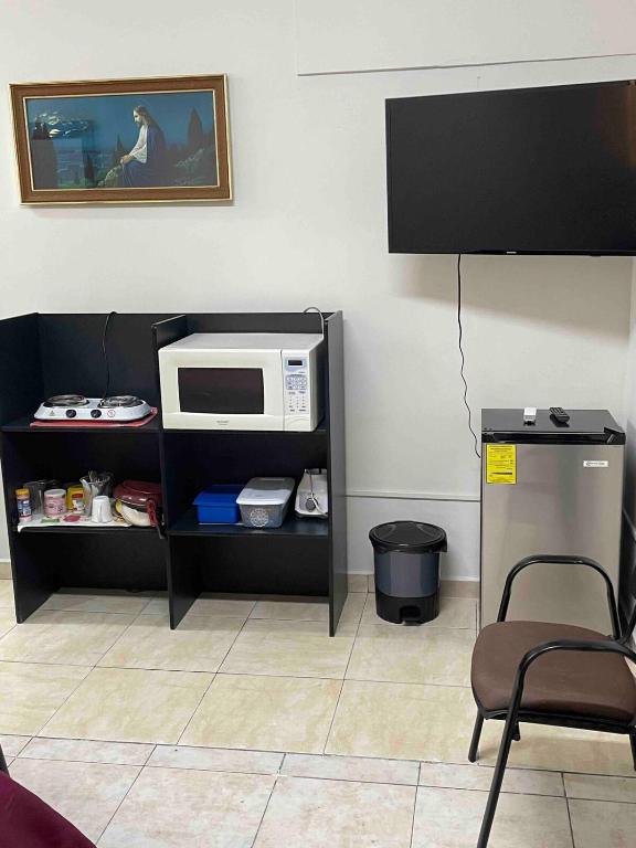 a microwave sitting on a shelf in a room at Loft 1 with 2 beds near Fundidora and Cintermex in Monterrey