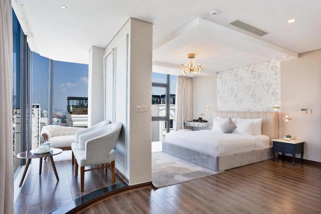 A spacious suite-style room combining a king bed with a separate sitting area by the window.