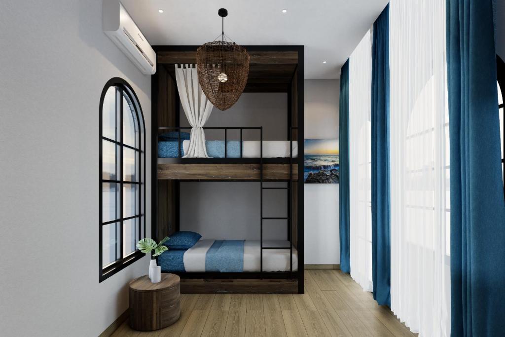 a room with a bunk bed in a house at Hotel SHOL Ninh Chu in Thôn Nhơn Sơn