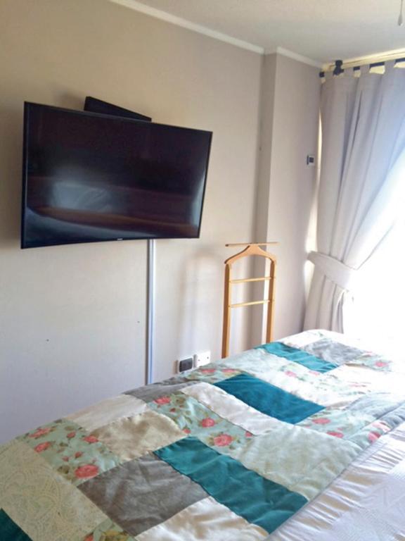 Postel nebo postele na pokoji v ubytování Apartamentos Terrazas de Talca
