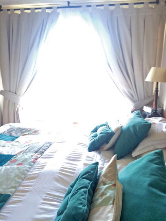 Postel nebo postele na pokoji v ubytování Apartamentos Terrazas de Talca