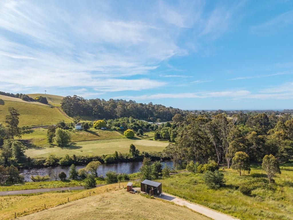 an aerial view of a farm with a train on the tracks at Perrys North by Tiny Away in Forth