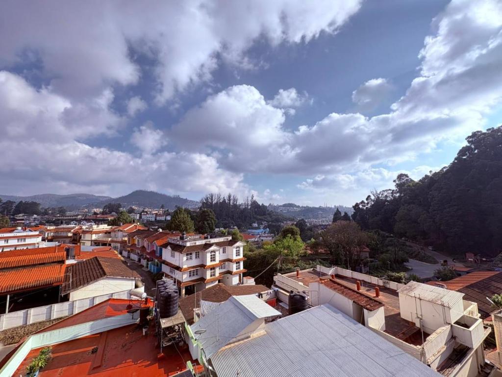 an aerial view of a city with buildings at The Hill Bunk Heights Ooty in Ooty