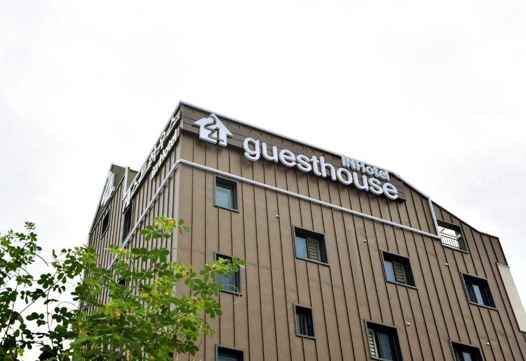 a building with a sign on the top of it at 24 Guesthouse Suncheon in Suncheon