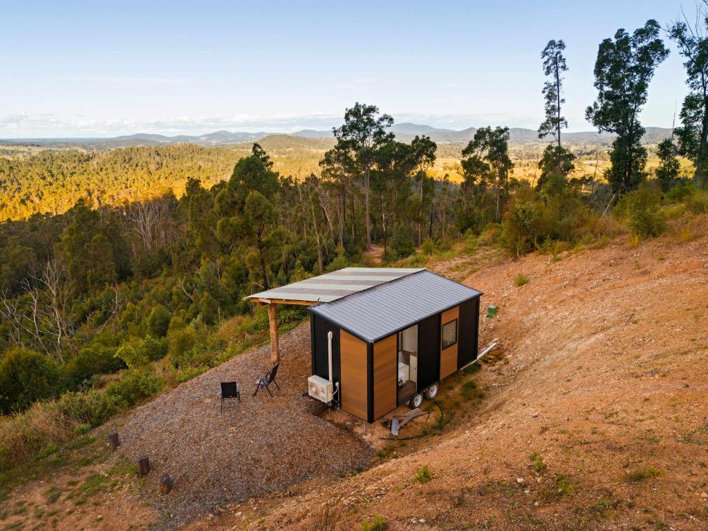 a tiny house sitting on top of a hill at Aurora Lookout by Tiny Away in Macksville